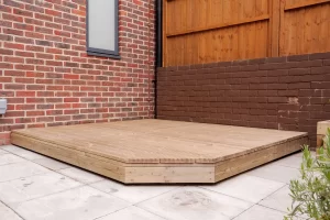 A newly built wooden deck in a back garden, illustrating the importance of deck maintenance and repair.